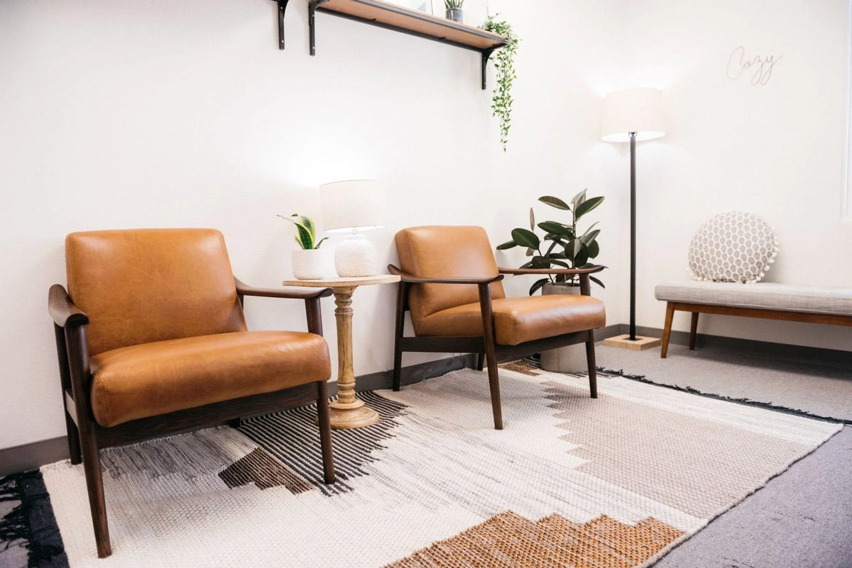 Modern living room with decorative throw pillows, framed wall art, indoor plants, and a styled coffee table creating a cozy and stylish home décor look.